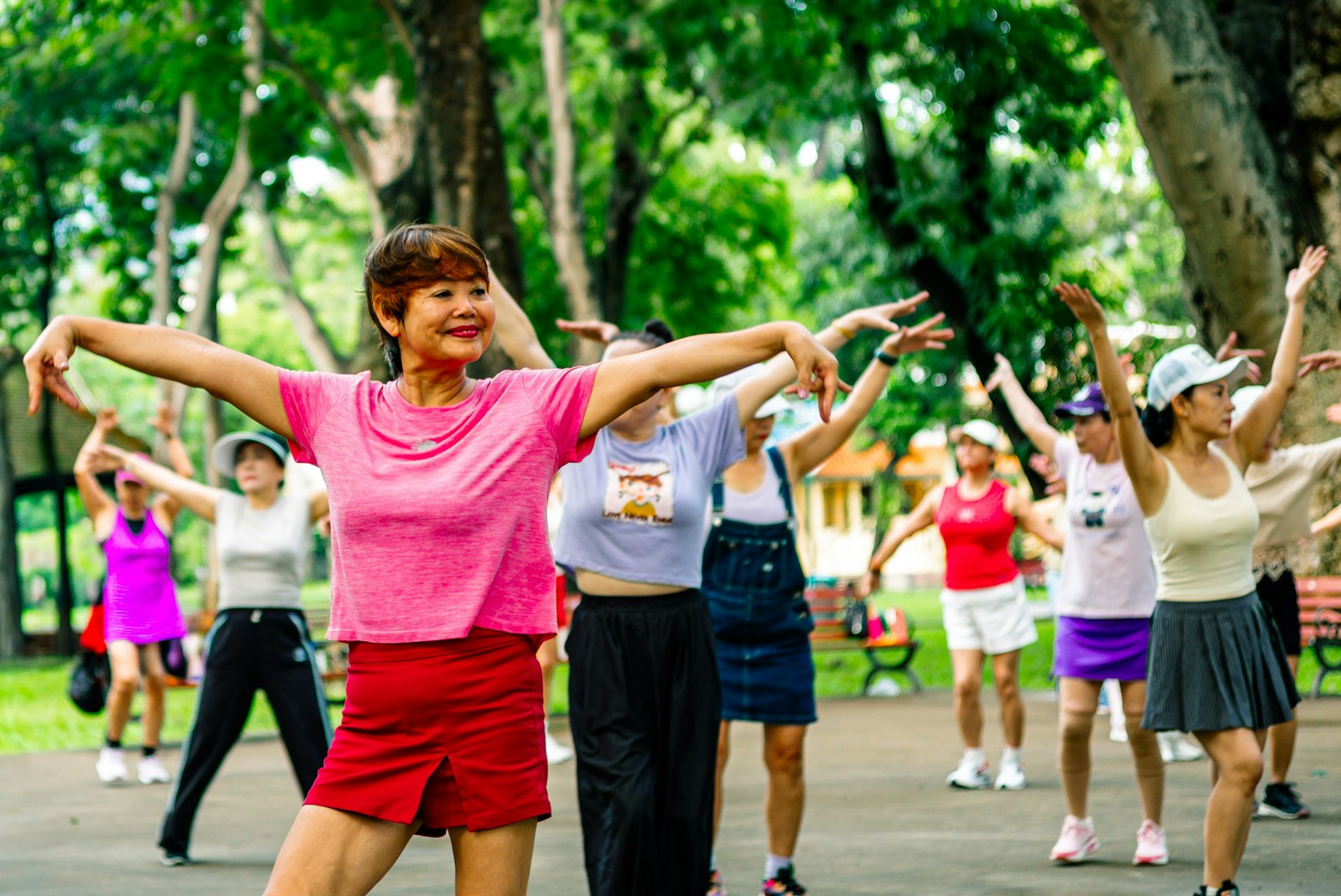 Group of women exercising together in a park.