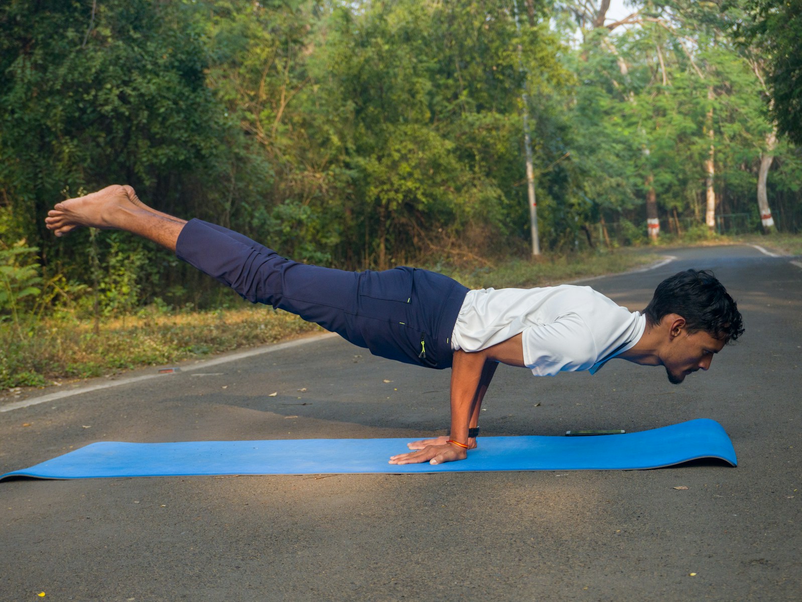 A man doing a push up on a blue mat
